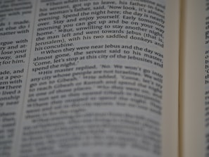 A close-up view of a page from a book, featuring printed text in English. The text is in a column format, with a focus that highlights certain words while others appear slightly blurred.