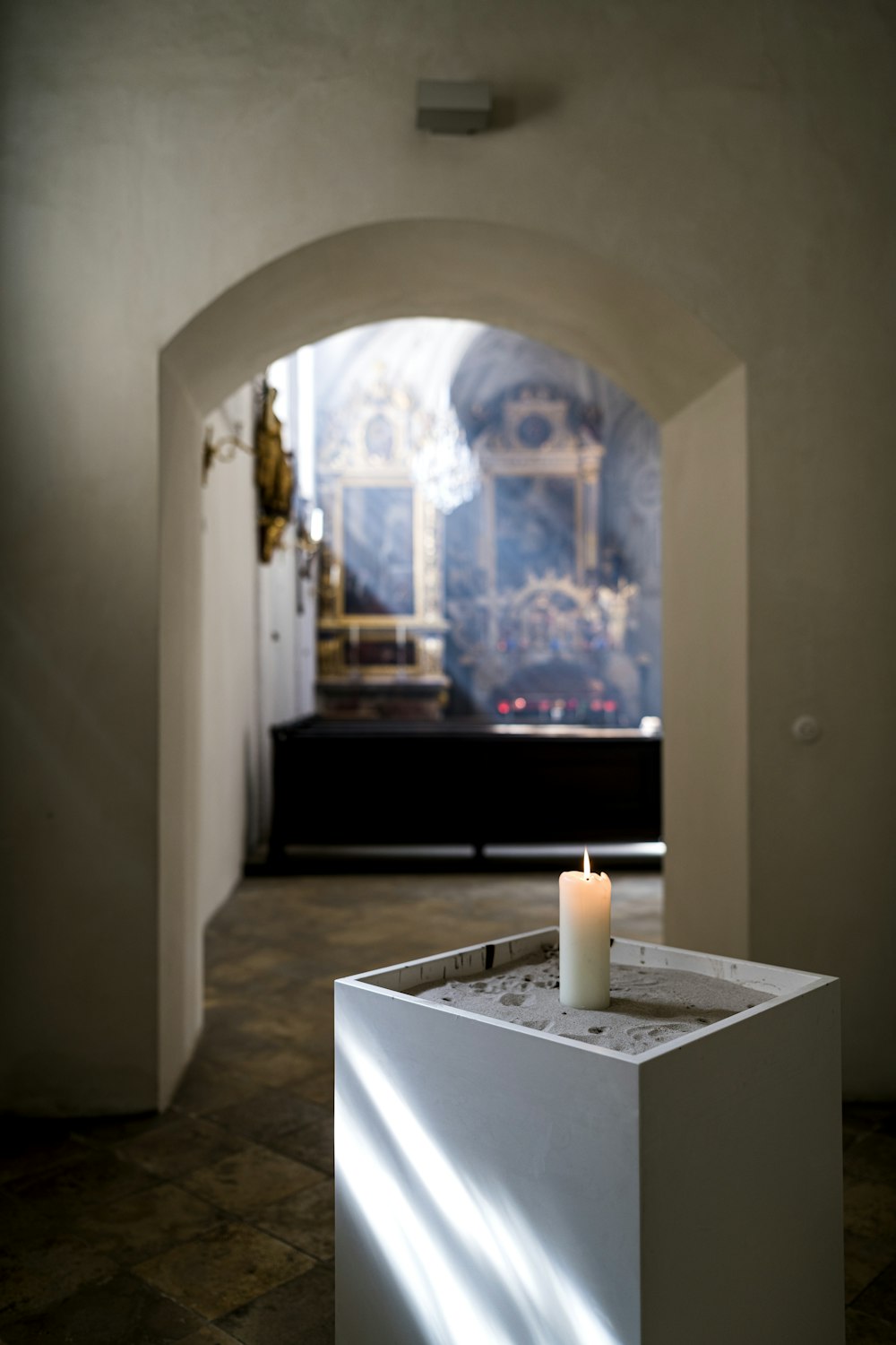 white candles on white wooden table