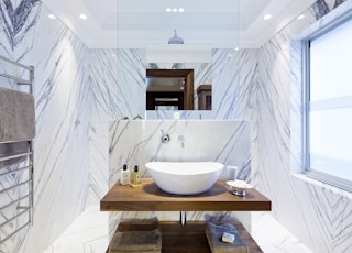 white ceramic sink on brown wooden table