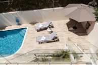 A well-designed outdoor space featuring a swimming pool and lounge area.