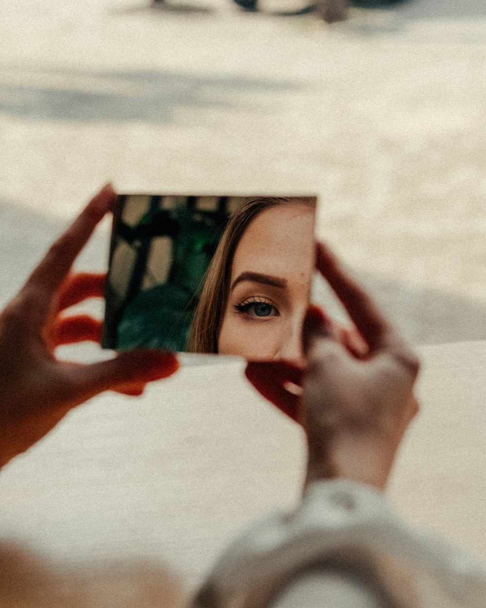 woman in white long sleeve shirt holding black and white photo frame