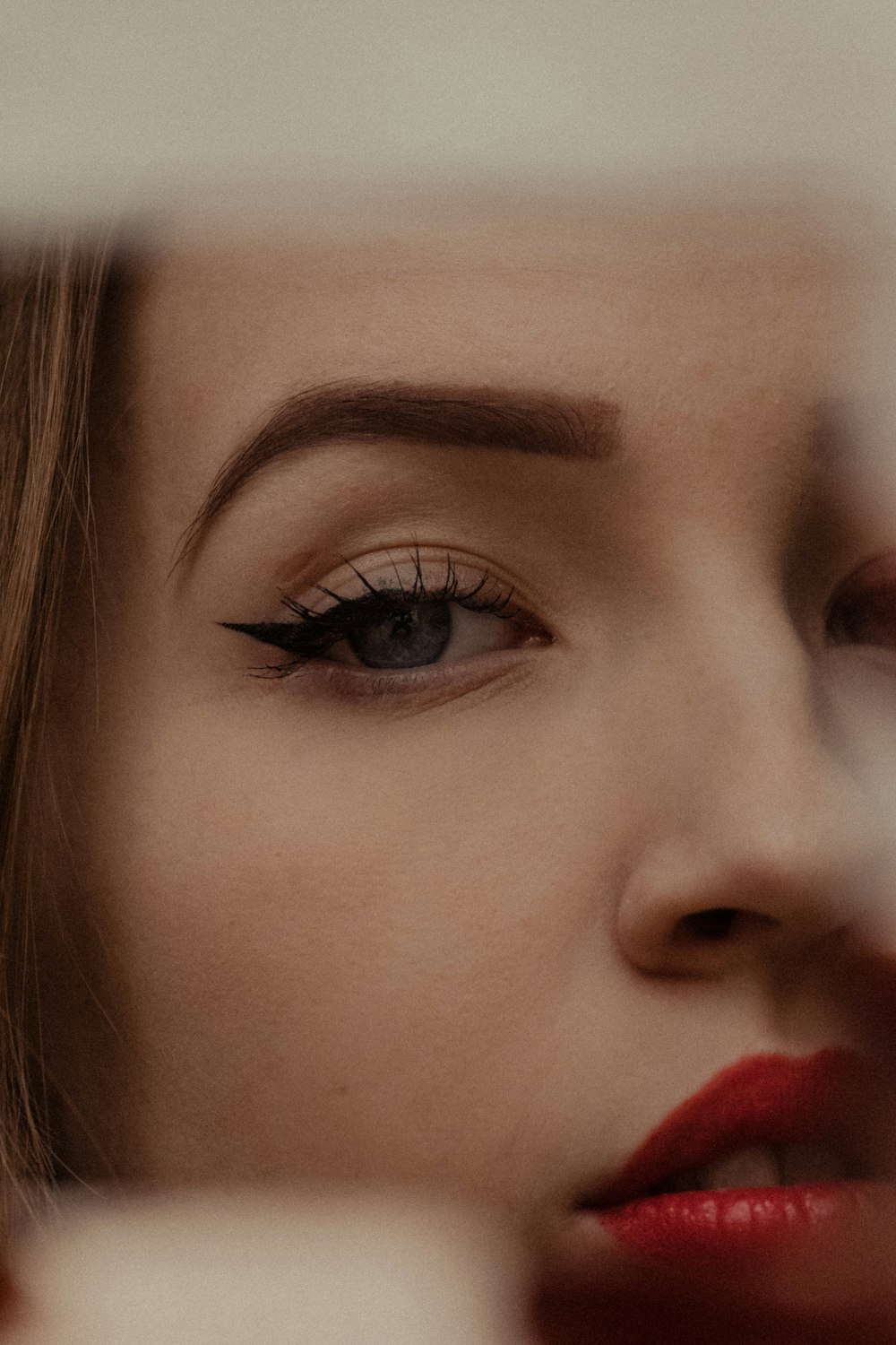 woman with black eyeshadow and red lipstick