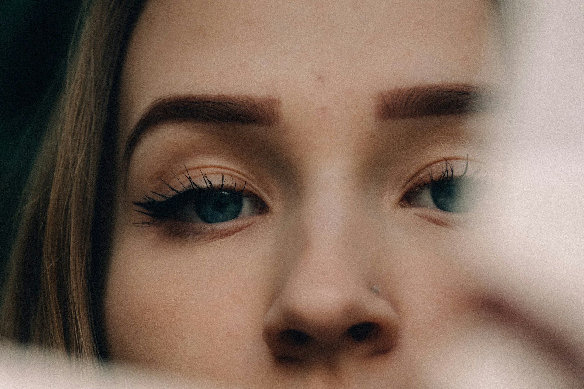 womans face with blue eyes