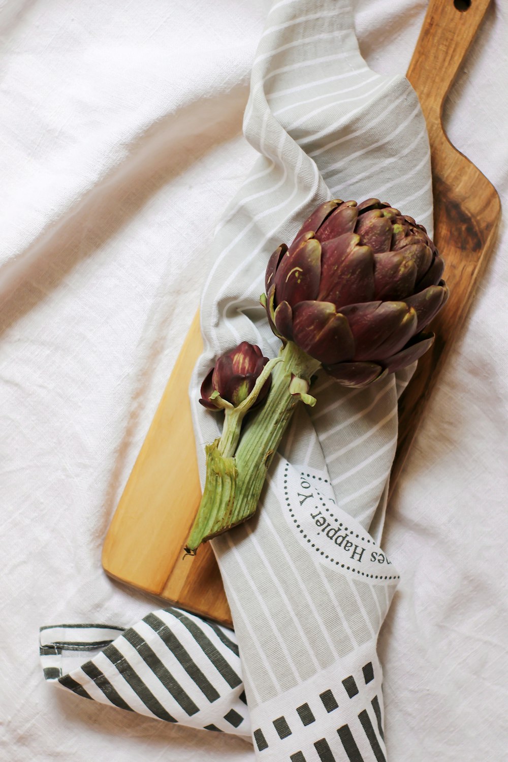 green and brown flower on white textile