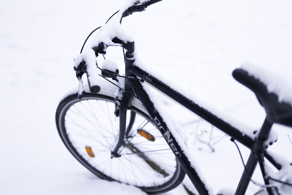 black bicycle covered with snow