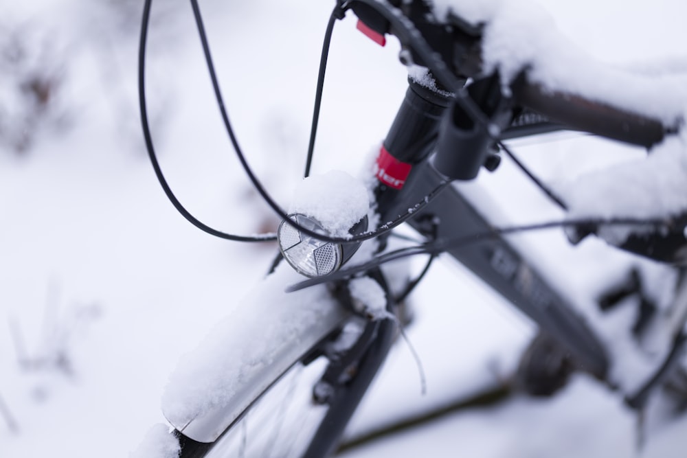 black bicycle on snow covered ground during daytime