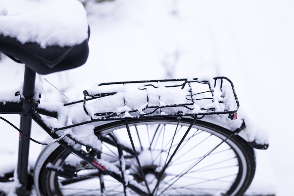 black bicycle covered with snow