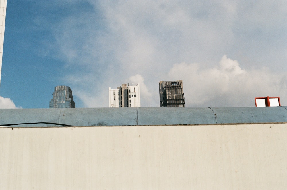 white concrete building under white clouds during daytime