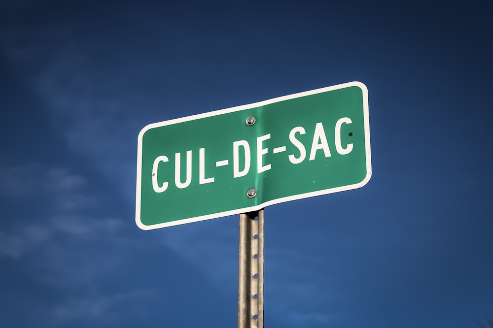 a close up of a street sign with a sky background