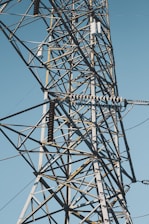 black electric tower under blue sky during daytime