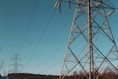 brown electric post under blue sky during daytime