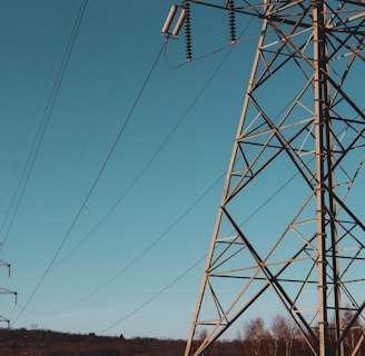 brown electric post under blue sky during daytime