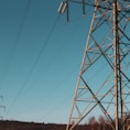 brown electric post under blue sky during daytime