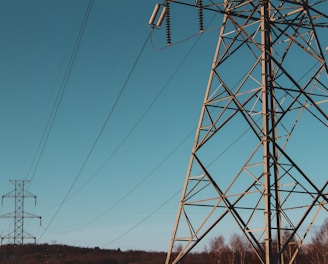 brown electric post under blue sky during daytime