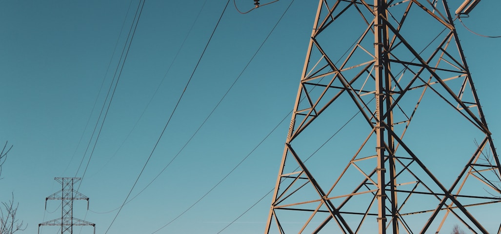 brown electric post under blue sky during daytime