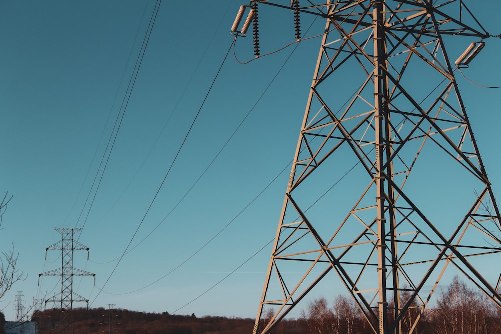 brown electric post under blue sky during daytime