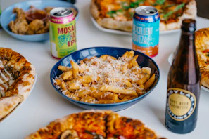 An overhead view of a large table filled with pizzas, salads, and dips at Slice Oasis.