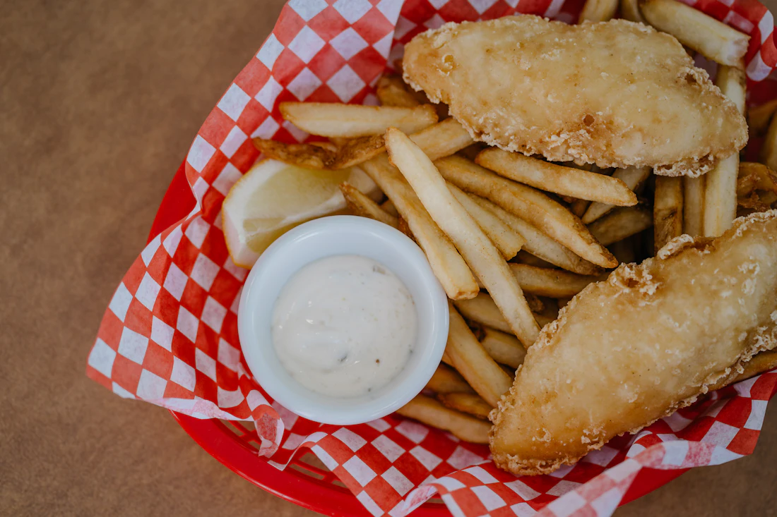 Battered fish fillets with a serve of hot chips