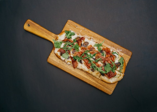 brown wooden chopping board with vegetable salad