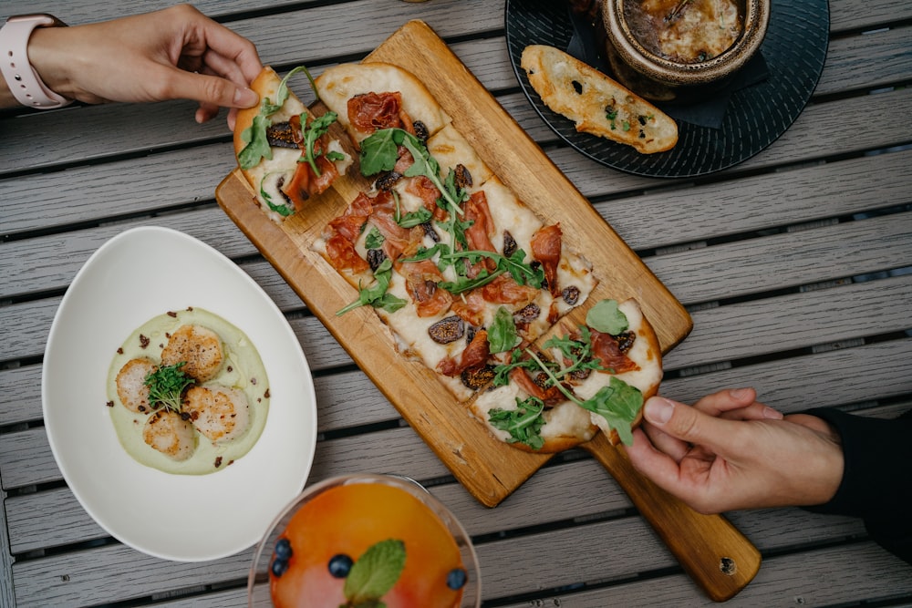 Pizza en rodajas en tabla de cortar de madera marrón