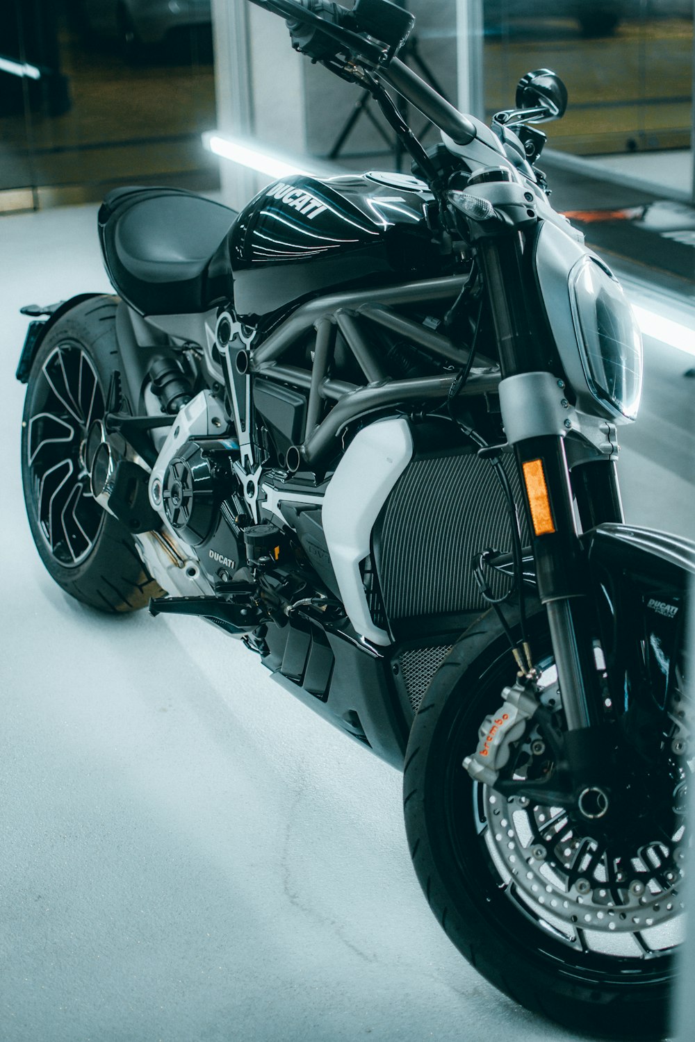 black and silver motorcycle on white floor