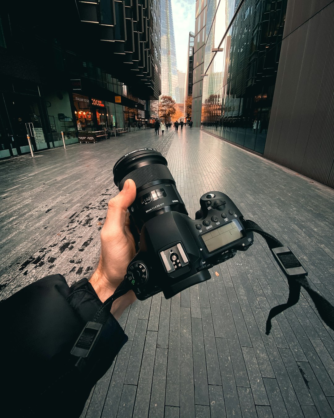 person holding black dslr camera