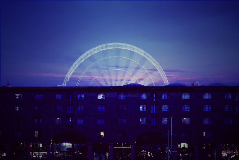 blue and white stadium with lights turned on during night time