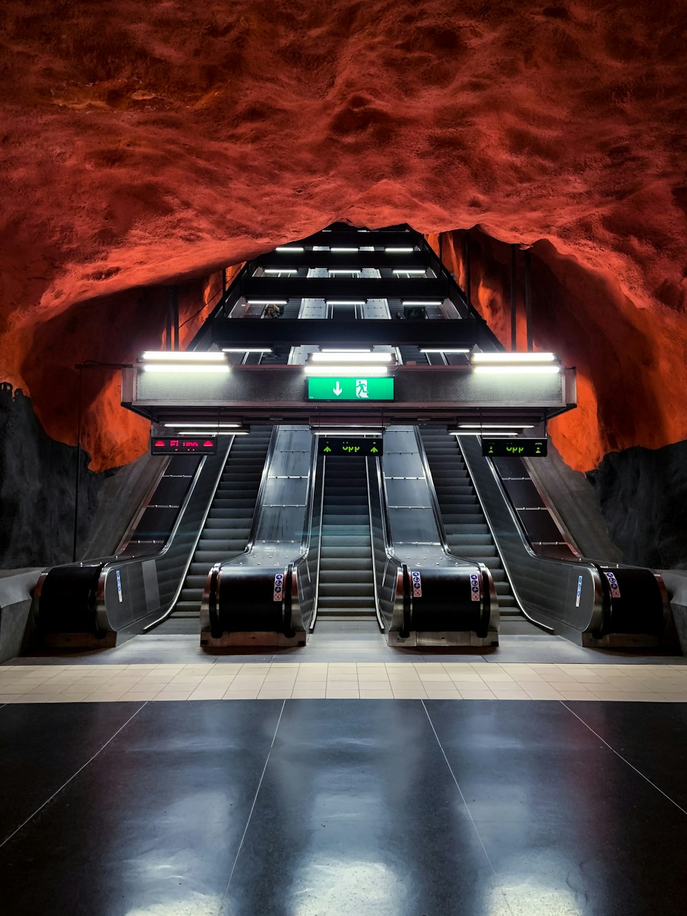 black and white escalator in a tunnel