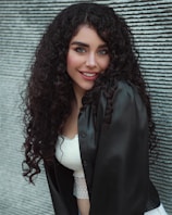 woman in black blazer smiling