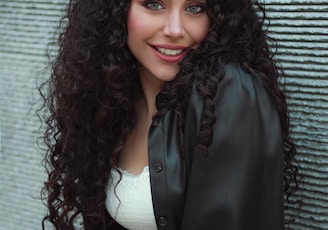woman in black blazer smiling