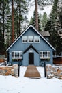 white and brown wooden house near green trees during daytime
