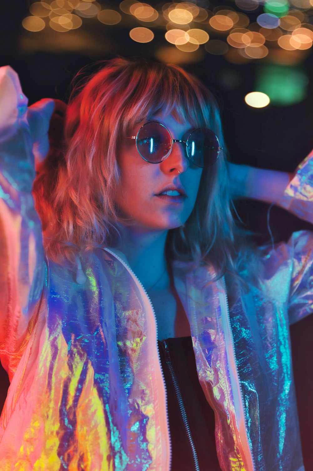 woman in blue and white floral shirt wearing black sunglasses