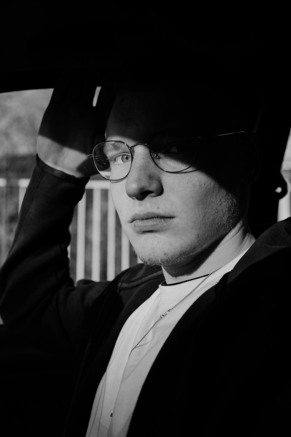 man in black suit jacket wearing black framed eyeglasses