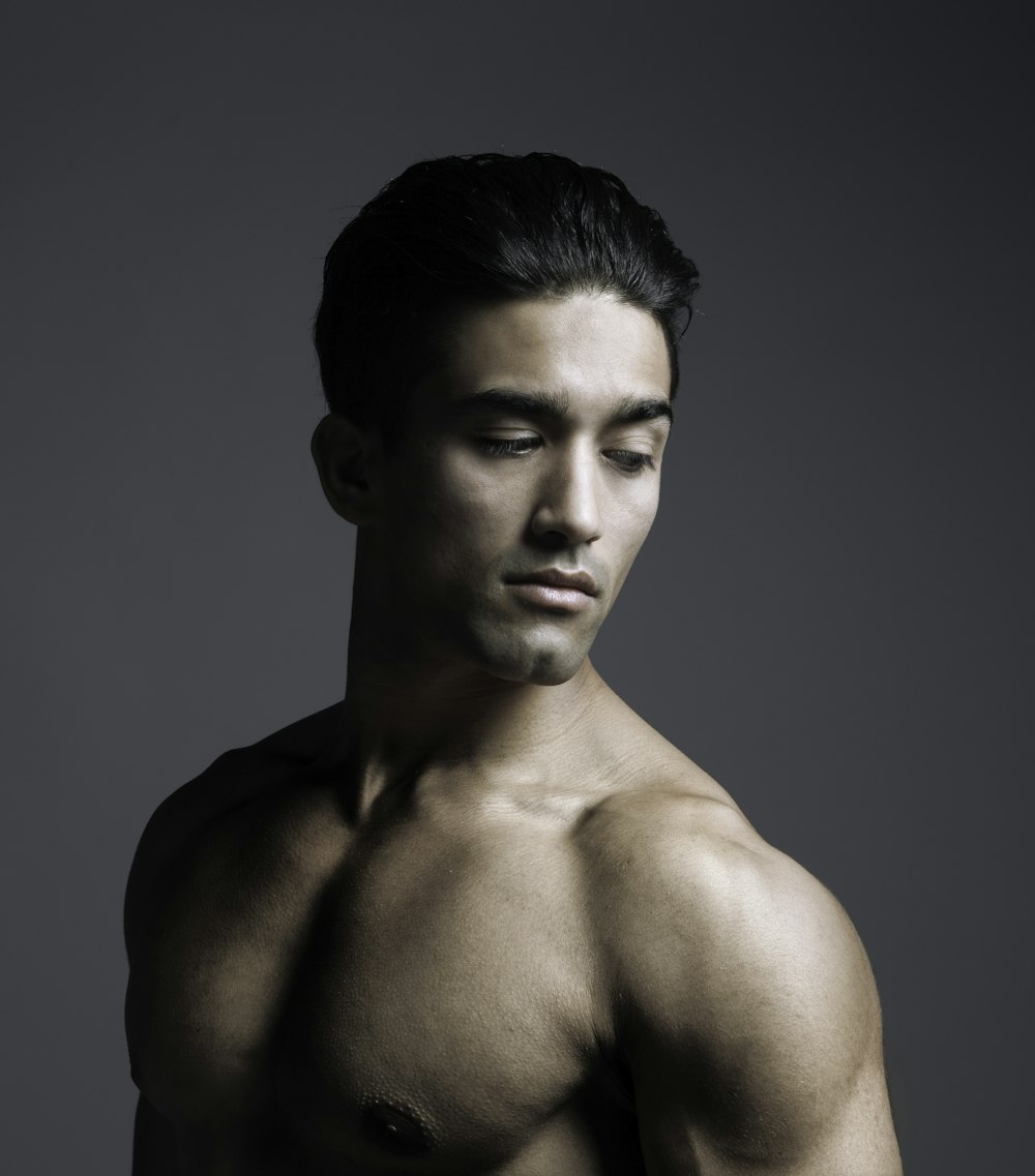 topless man with black background