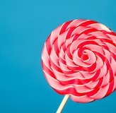 white and red lollipop on blue background