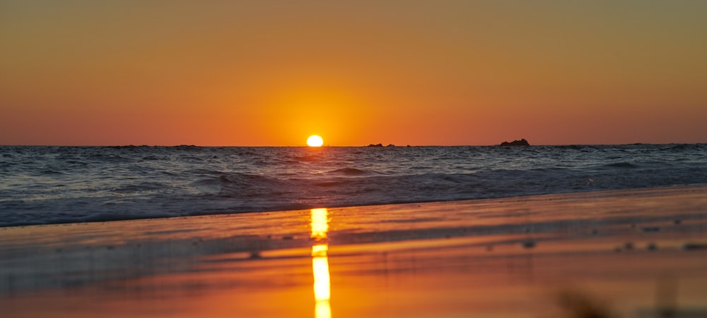 body of water during sunset