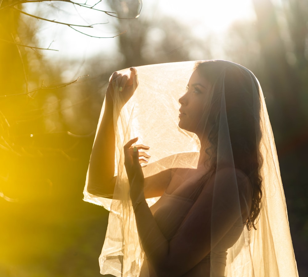 woman in white dress sitting on white textile