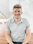 man in gray polo shirt smiling
