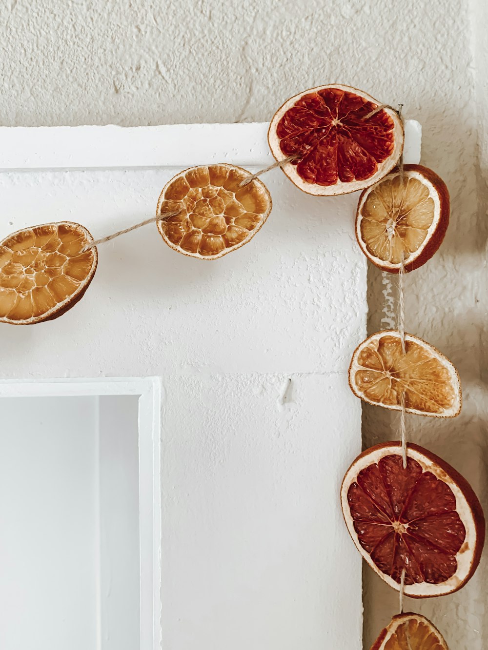 sliced orange fruit on white wooden wall rack