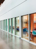 Bright hallway with colorful mobile partitions adding vibrancy and privacy.