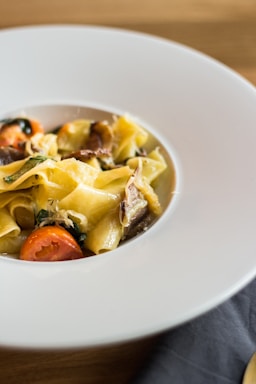 A vibrant plate of pasta garnished with herbs.