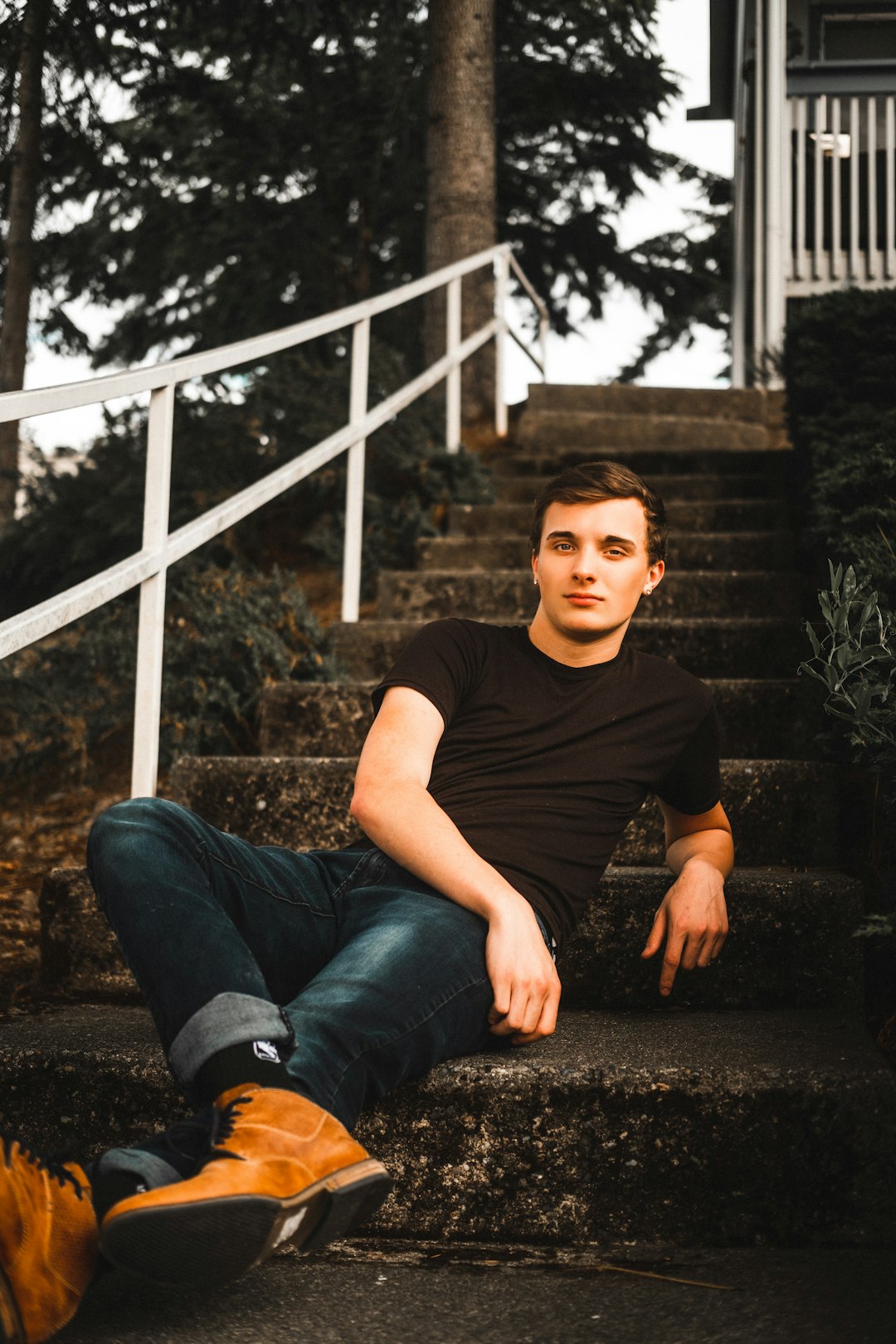 woman in black crew neck t-shirt and blue denim jeans sitting on stairs