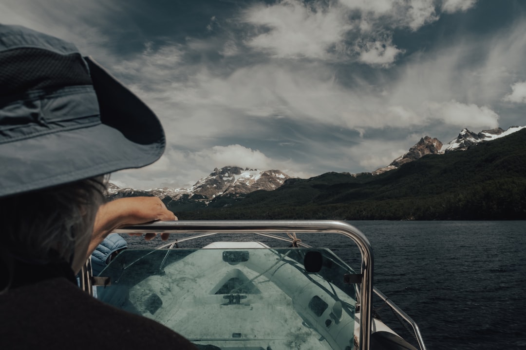 person in black hat riding on boat during daytime