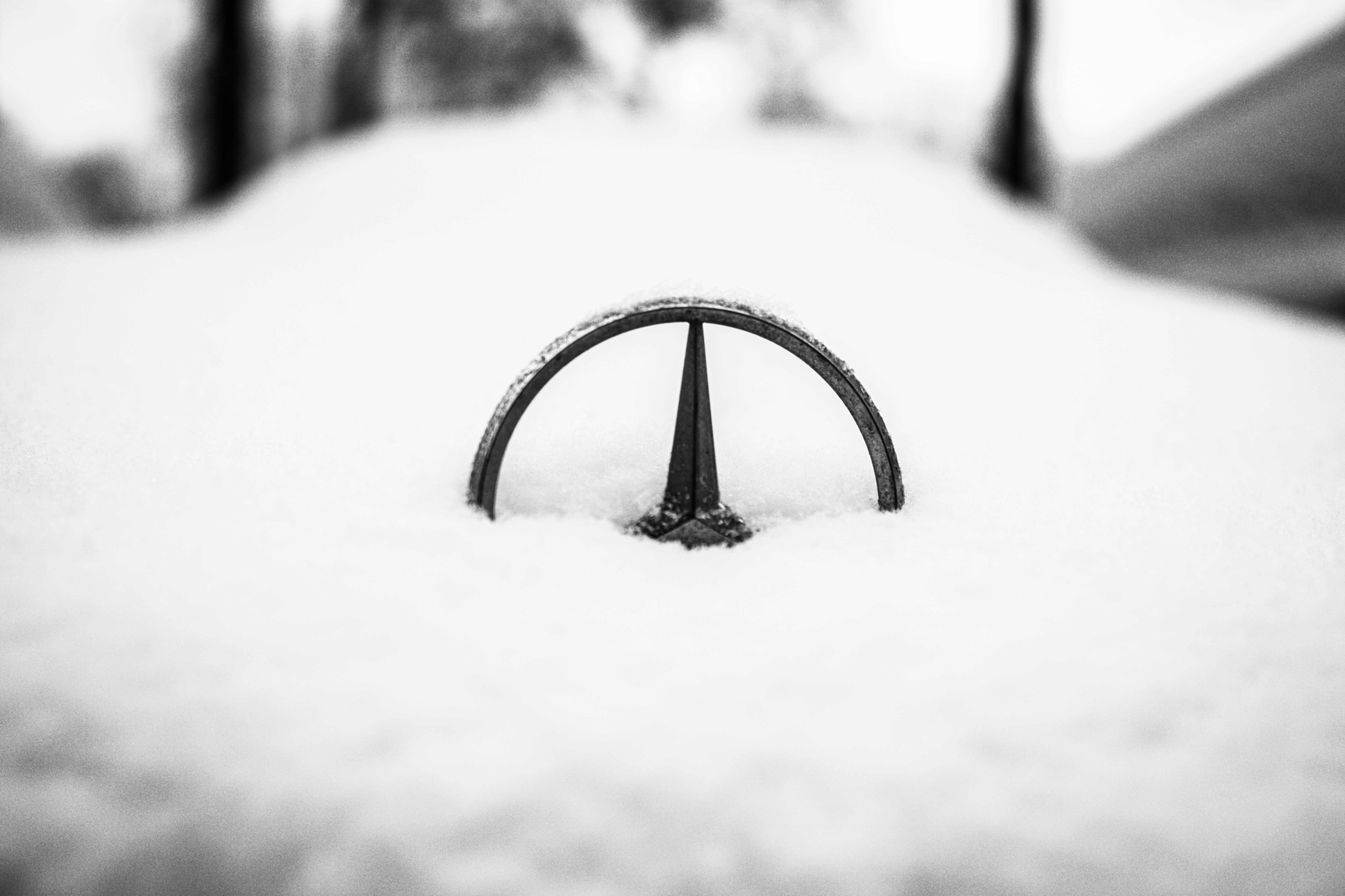 Mercedes Benz logo hidden by snow on a cars nose in Stuttgart, Germany