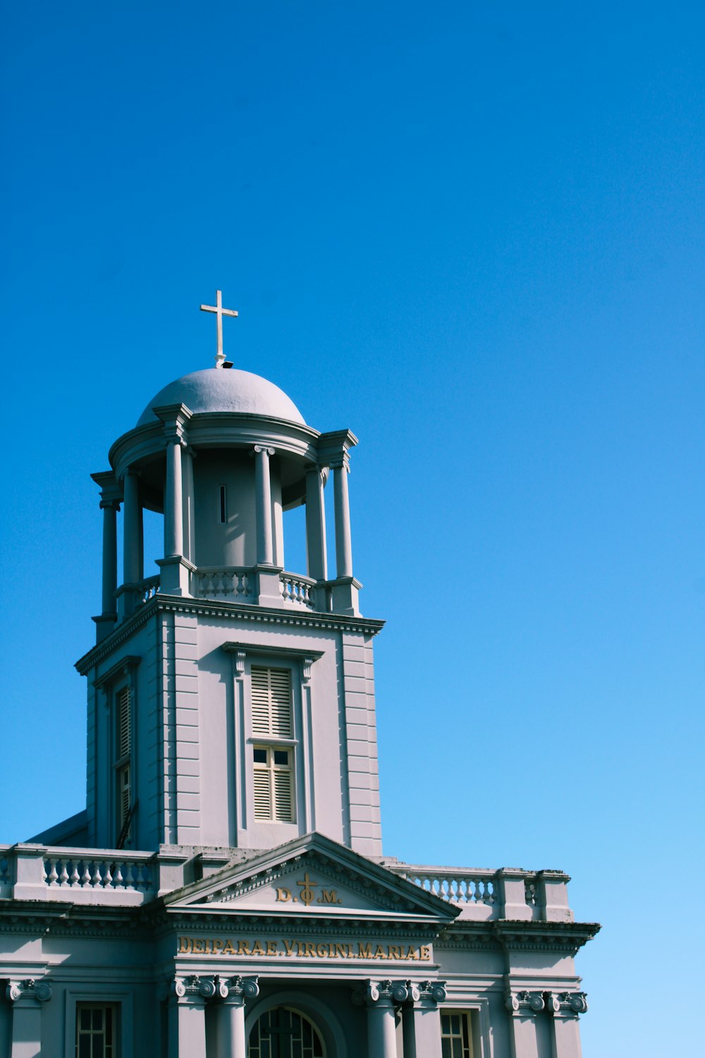 white and brown concrete church under blue sky during daytime