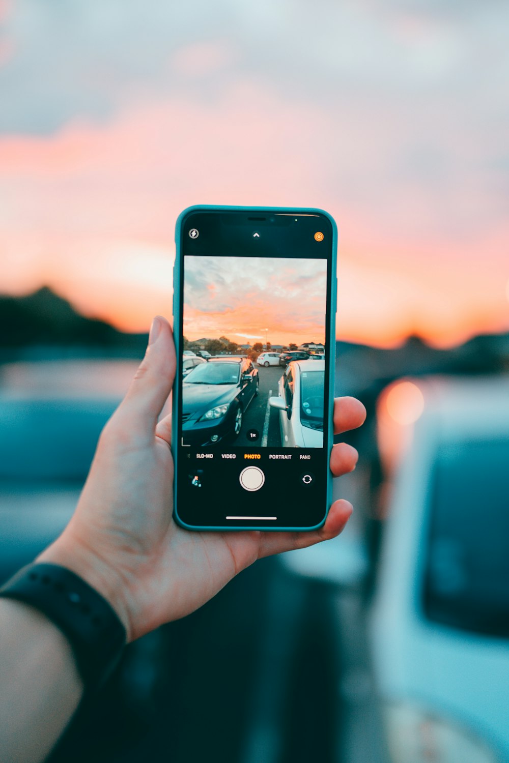 person holding black iphone 5 taking photo of body of water during daytime