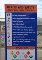 Safety signage and protocols displayed in a modern factory setting.