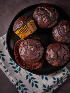 chocolate cupcakes on blue and white ceramic plate