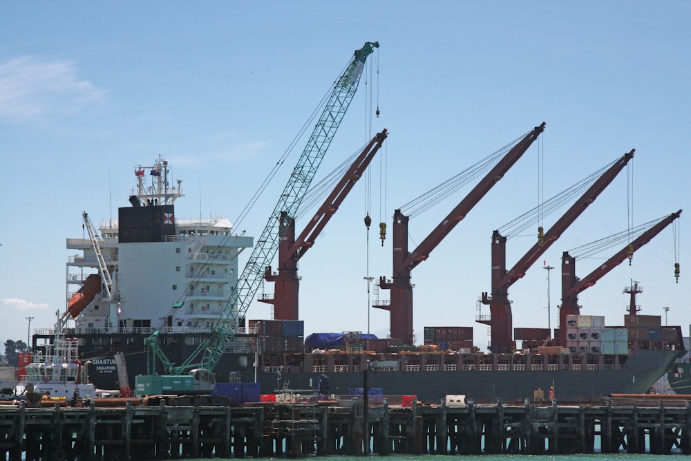 gray and red crane under blue sky during daytime