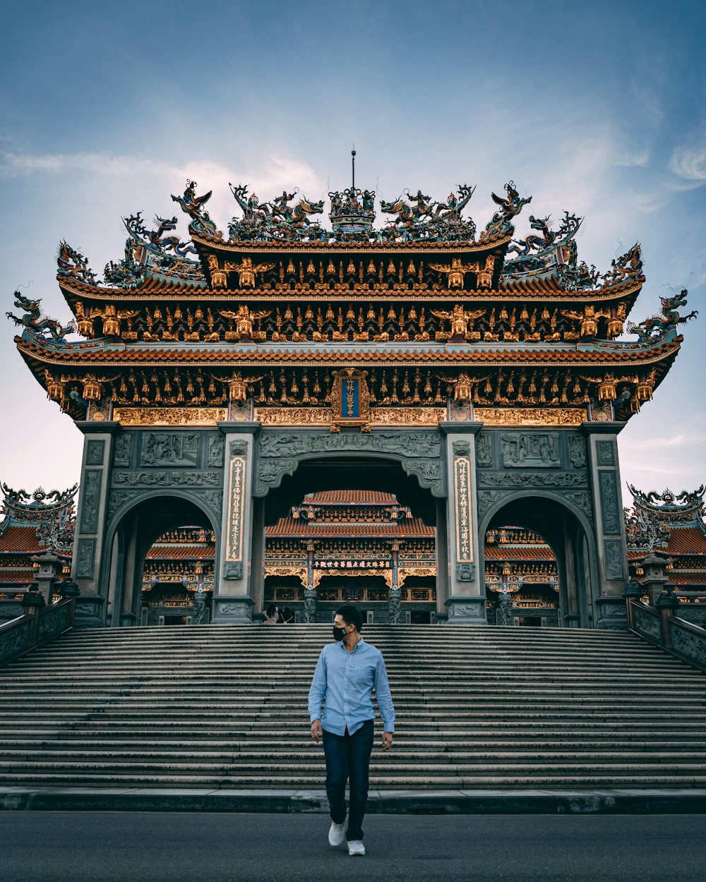 man in white shirt sitting on brown wooden stairs